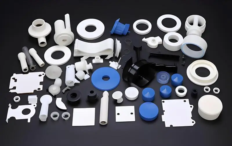 Various plastic injection molded parts on a black surface