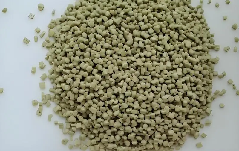 Beige ABS injection molding plastic pellets on a white background