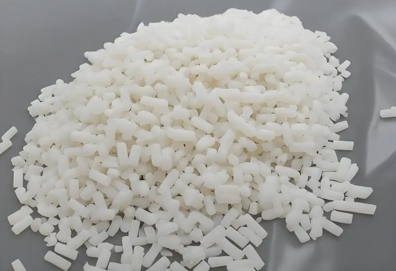 White plastic pellets on a gray background