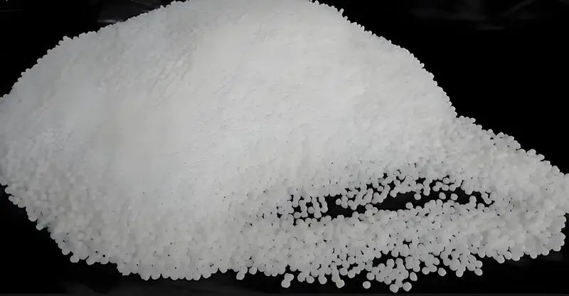 pile of white injection molding material polyoxymethylene (POM) on a black background