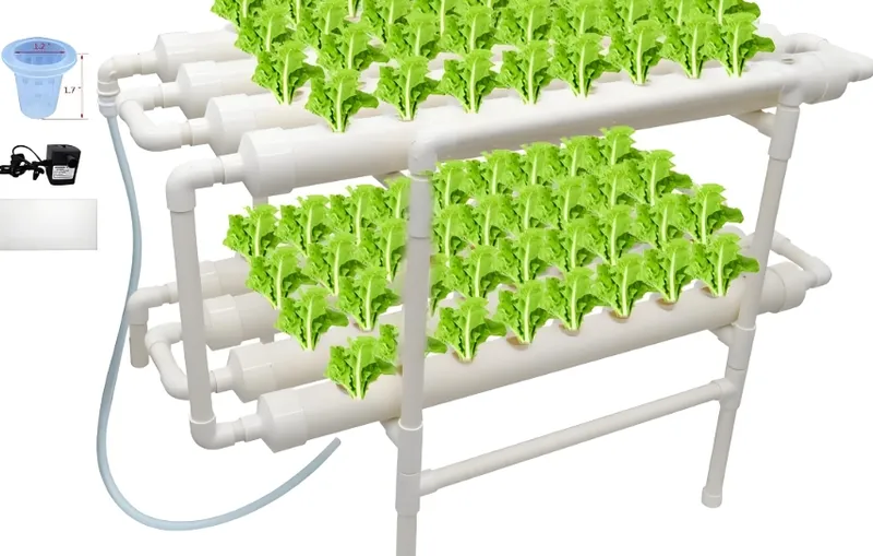 A hydroponic planting system with three levels of white PVC pipes filled with green leafy plants, accompanied by a water pump and a measuring cup