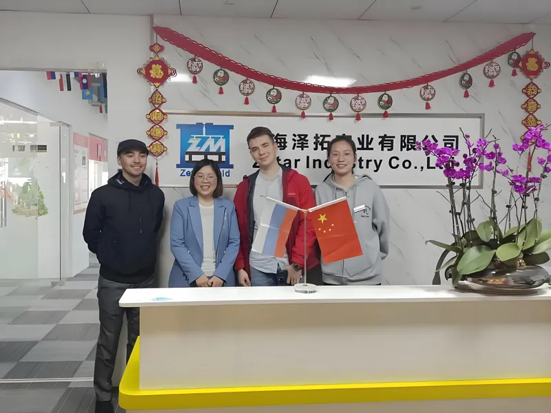 Group of people standing at Ze'an Mold and Star Industry Co., Ltd. office with decorations and flags