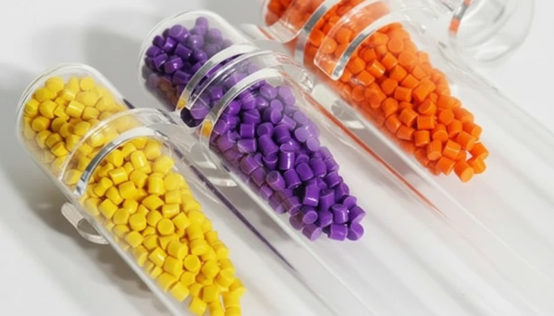 Various colored and transparent plastic pellets in test tubes for material selection
