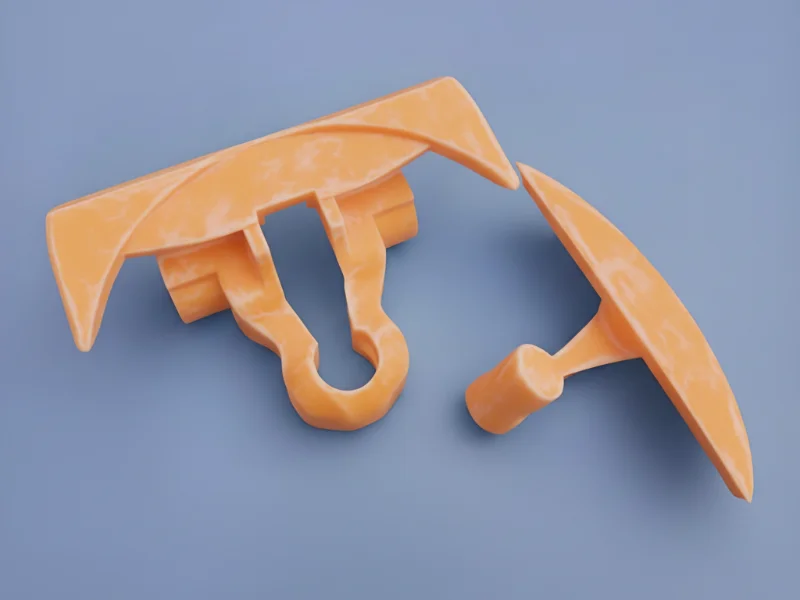Two orange plastic parts of a tile leveling system on a blue background, used for aligning and leveling tiles in construction projects.